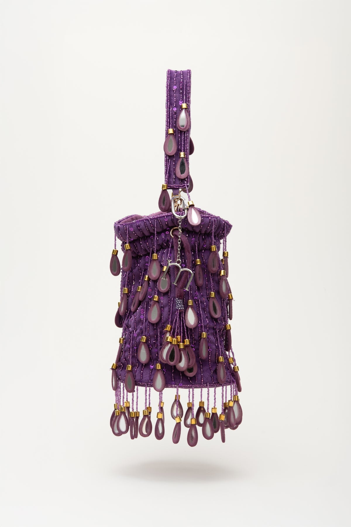 Purple Elio beaded bag with amethyst stone drops, gold accents, and shoulder strap from Martinas handcrafted collection