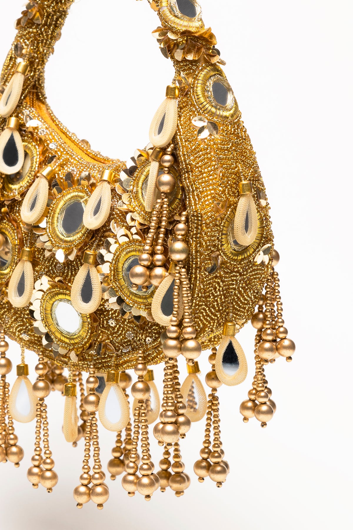 Gold Formentera beaded bag detail showcasing handcrafted micro-bead embroidery, mirror-glass pendants, and layered gold fringe
