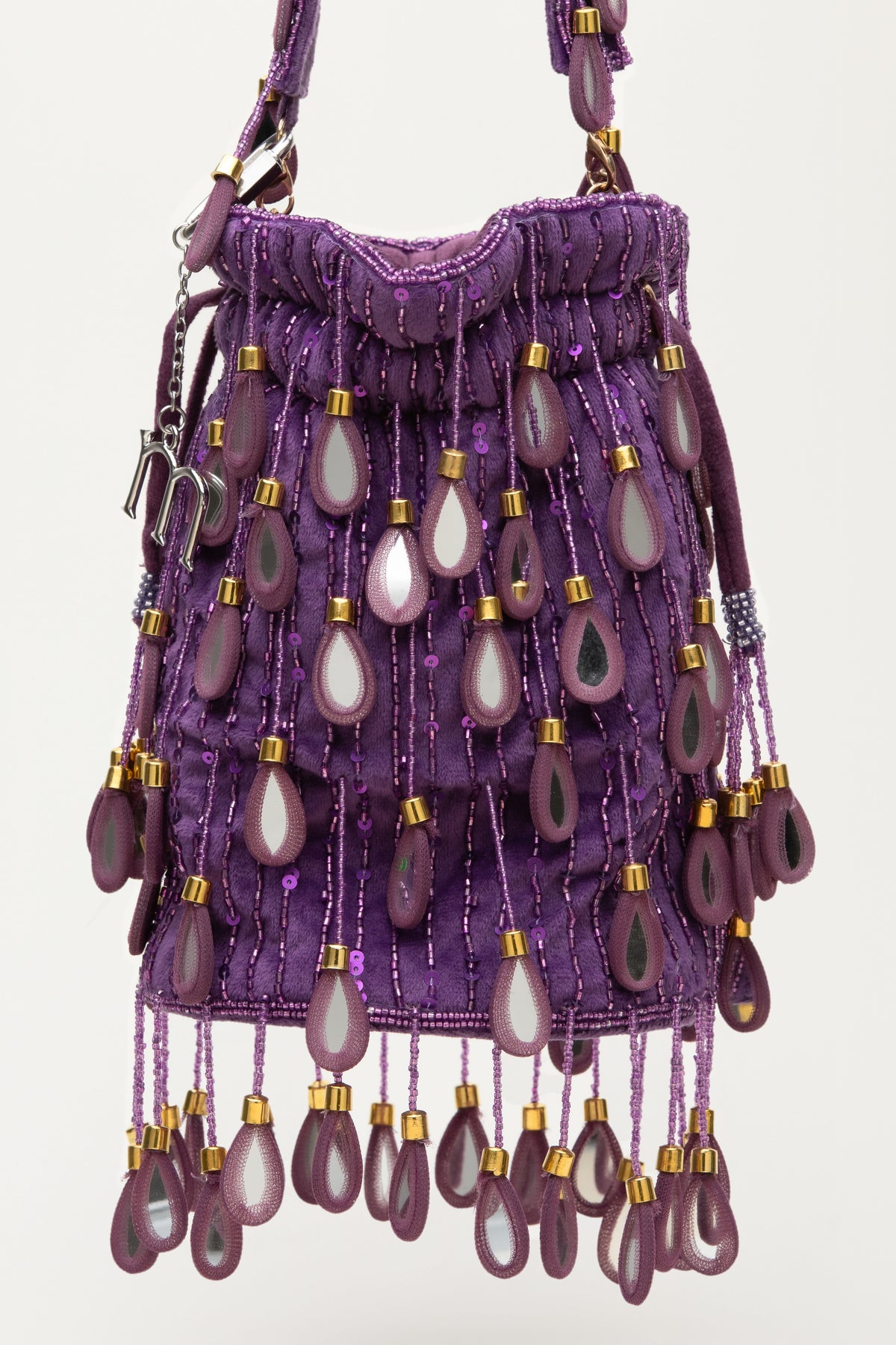 Purple Elio beaded bag with teardrop embellishments, gold accents, and fringe detailing, handcrafted Mediterranean luxury accessory