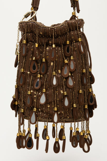 Brown Elio bucket bag with cascading teardrop mirror glass details, sequins, and fringed base, handcrafted Mediterranean statement accessory