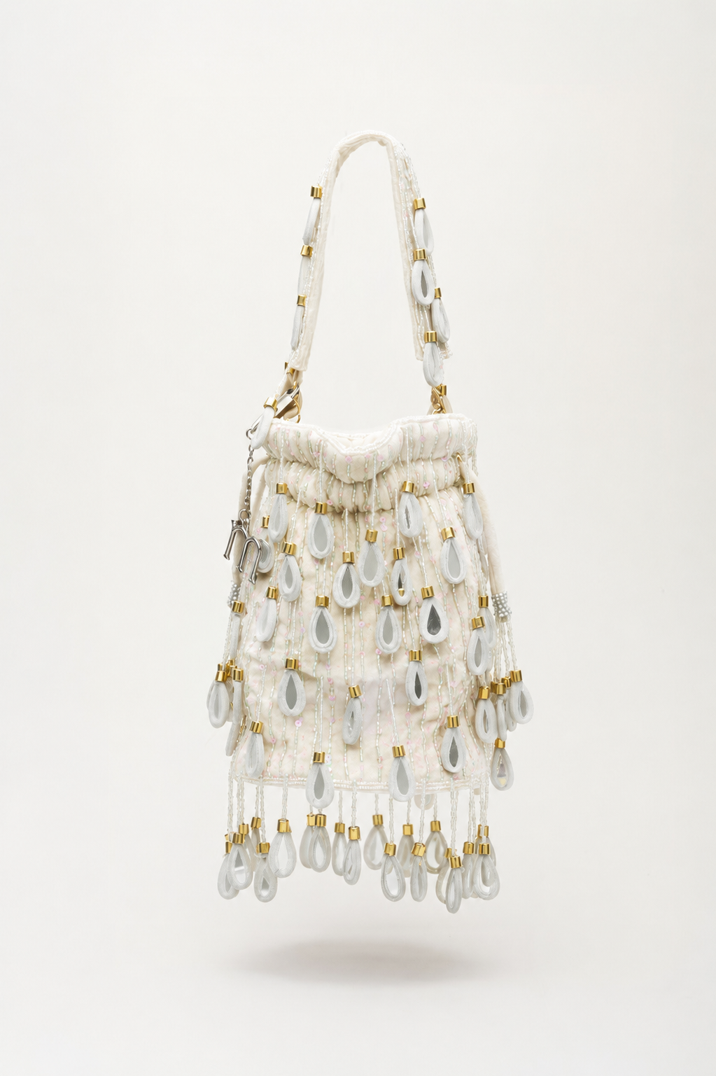 White Elio beaded bag with cascading pearlescent drops, gold accents, and double magnetic closure by Martinas