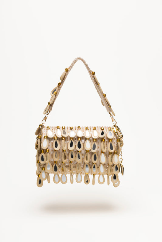 Handcrafted beige Martinas bag with mirror-glass teardrop pendants in sand and cream tones, featuring textured sequin base and draped fringe design