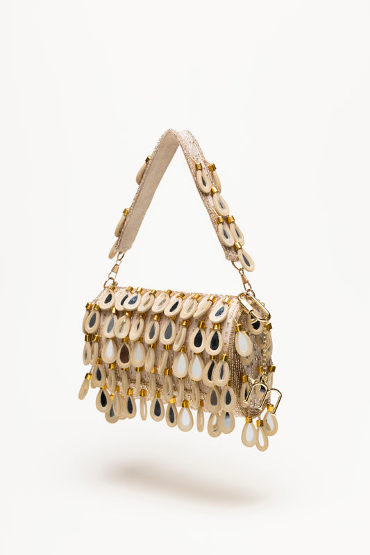 Handcrafted beige shoulder bag with cascading mirror-glass teardrop pendants in cream and sand tones, textured sequin base, gold hardware, statement piece