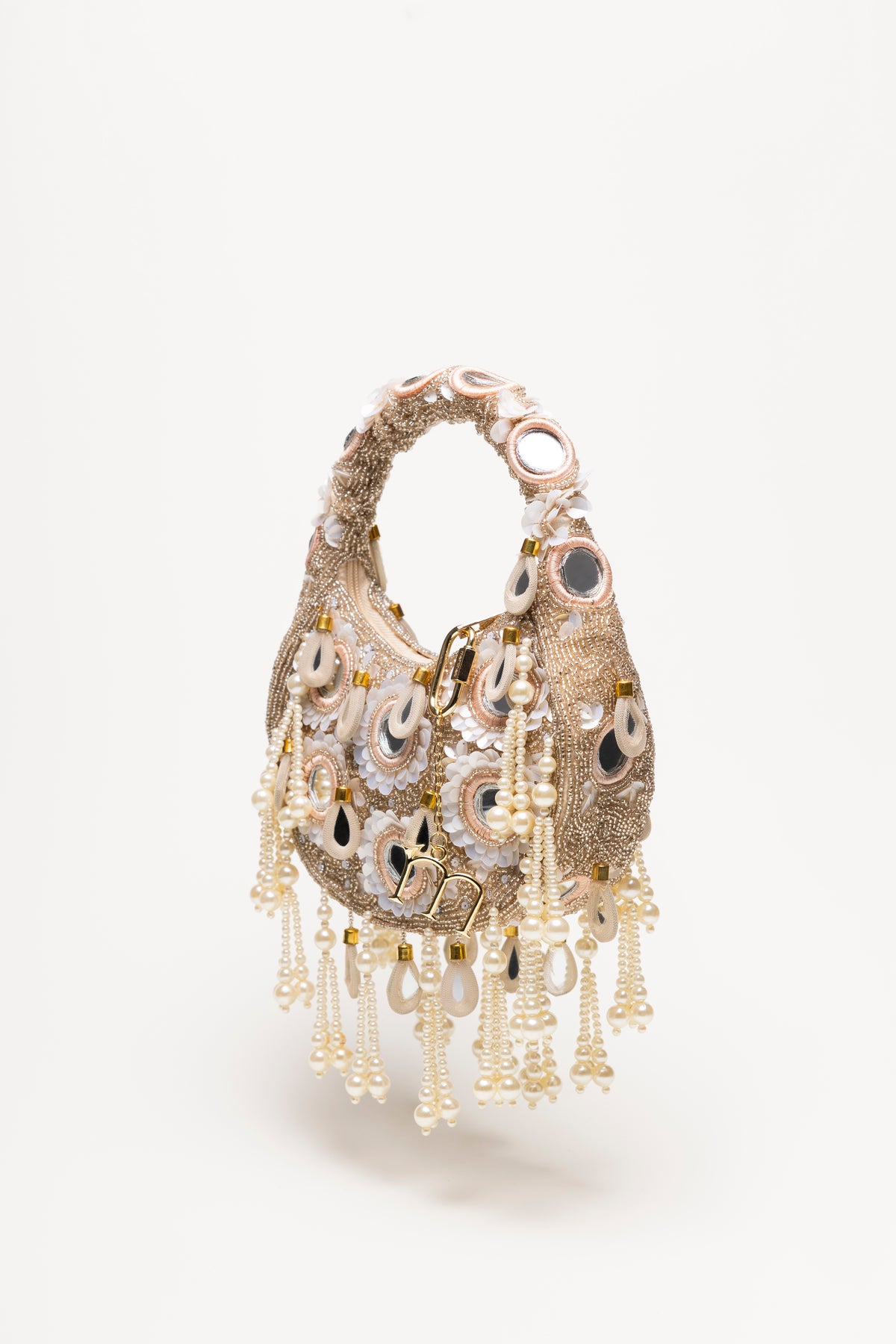 Beige Formentera beaded bag with hand-embroidered pearl strands, mirrored details, and gold accents