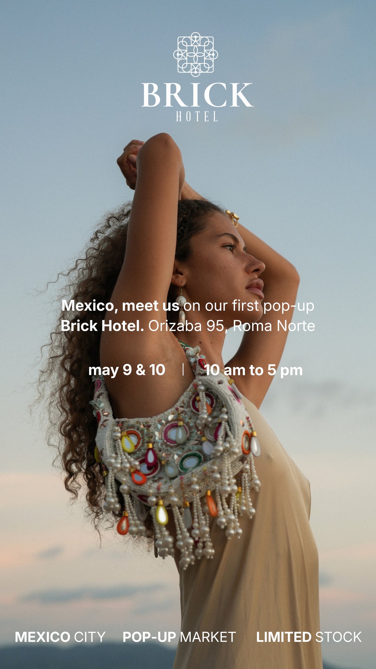 Woman wearing beaded statement bag and cream dress at Brick Hotel pop-up Mexico City event